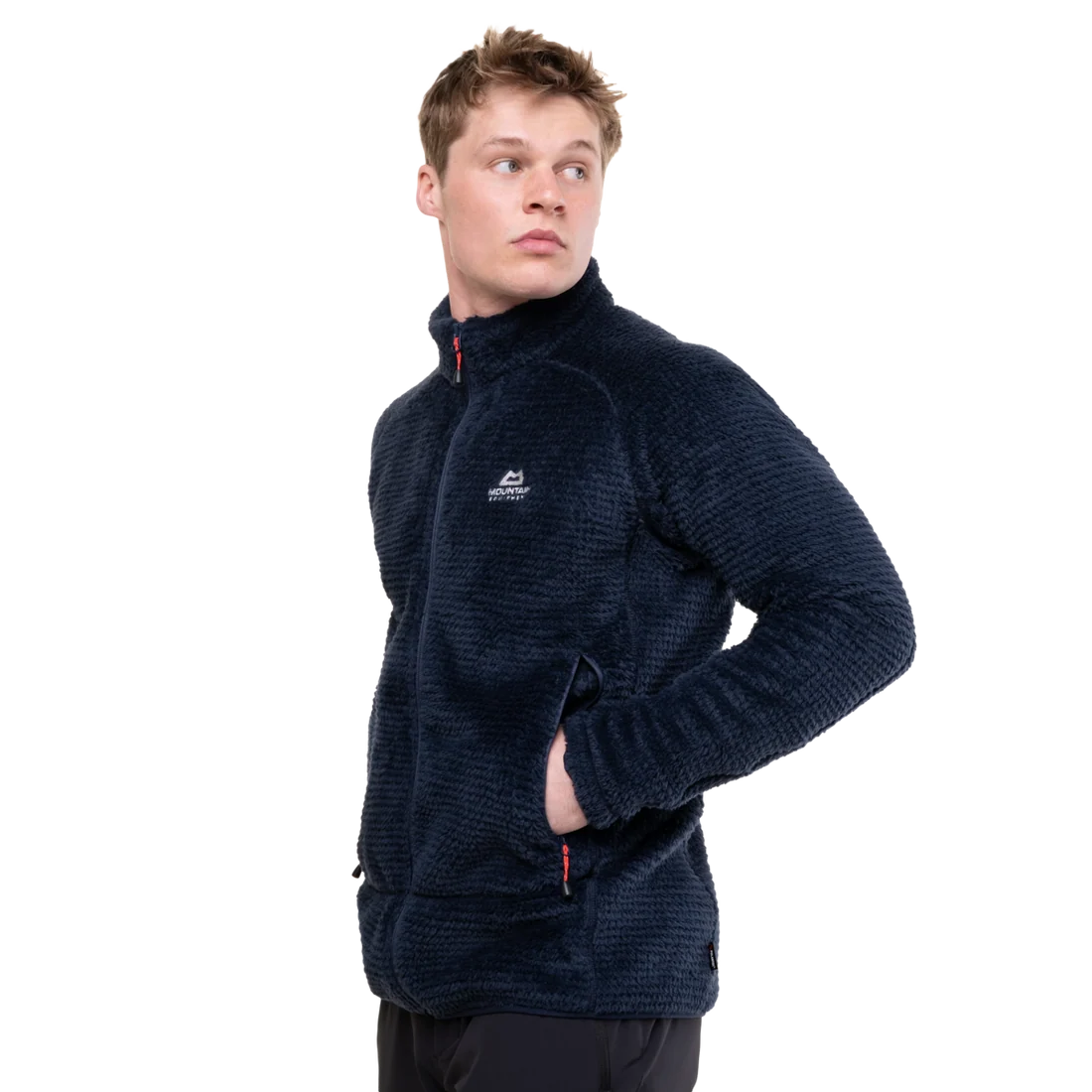 A man wearing a dark navy textured fleece jacket with a white embroidered logo on the left chest, shown from a three-quarters angle against a plain white background.